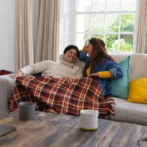 A couple spending time together while covered in blankets