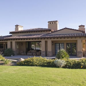 A sunlit garden of a beautiful house on a sunny day