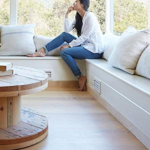 Woman sitting by window vent pillows