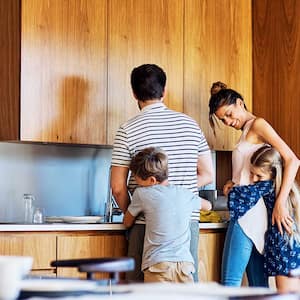 Family hugging in kitchen