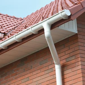 White painted gutters in a brick house