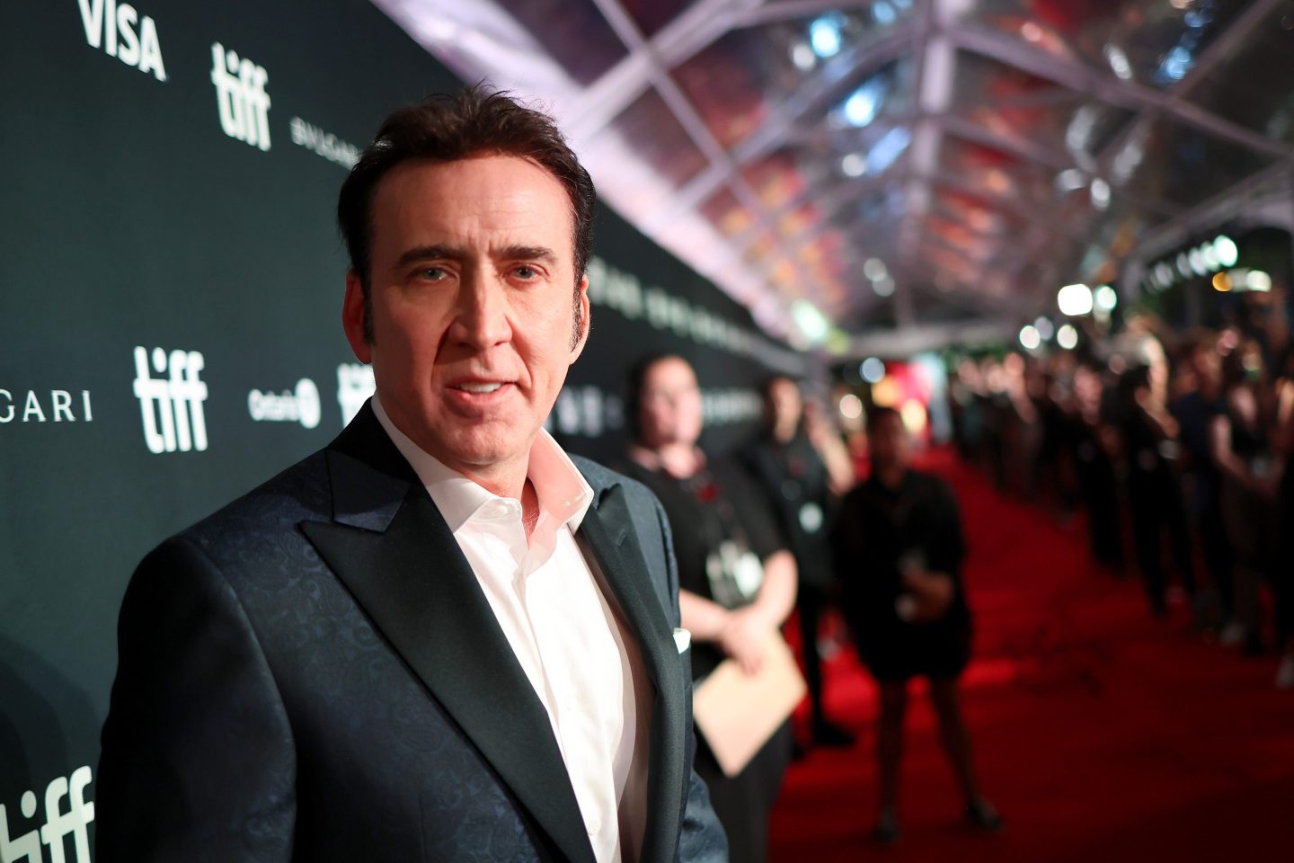 Nicolas Cage stands on a red carpet at the Toronto International Film Festival