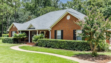 Front view of red brick house in the suburbs