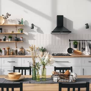  A modern kitchen with a black range hood