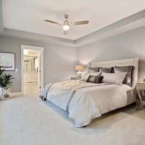 A beautiful bedroom with a white carpet