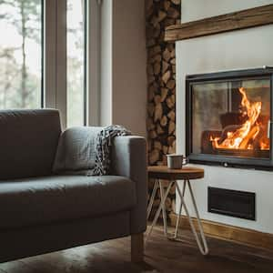 A cozy living room with a burning fireplace