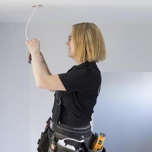 A female electrician renovating house