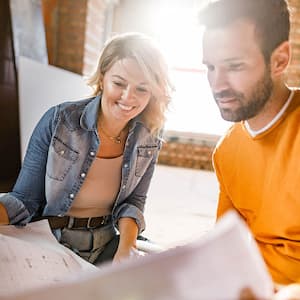 couple looking over blueprints for garage conversion