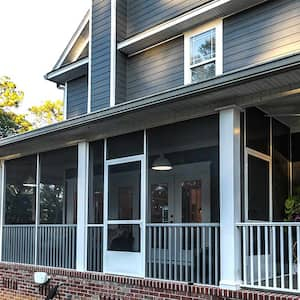 Blue two-story house with screened-in wrap around porch