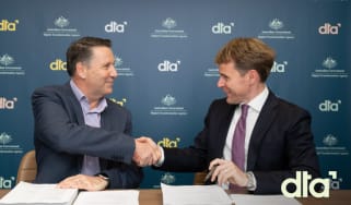 Chris Fechner, DTA CEO, and Nicholas Flood, Managing Director of IBM Australia shaking hands after signing the agreement