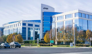 A white brick office site with blue windows with the word Citrix displayed on the tallest building