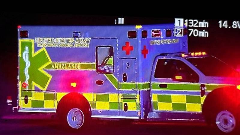 An ambulance leaves the scene of a Blackhawk crash in Cadiz, Kentucky.