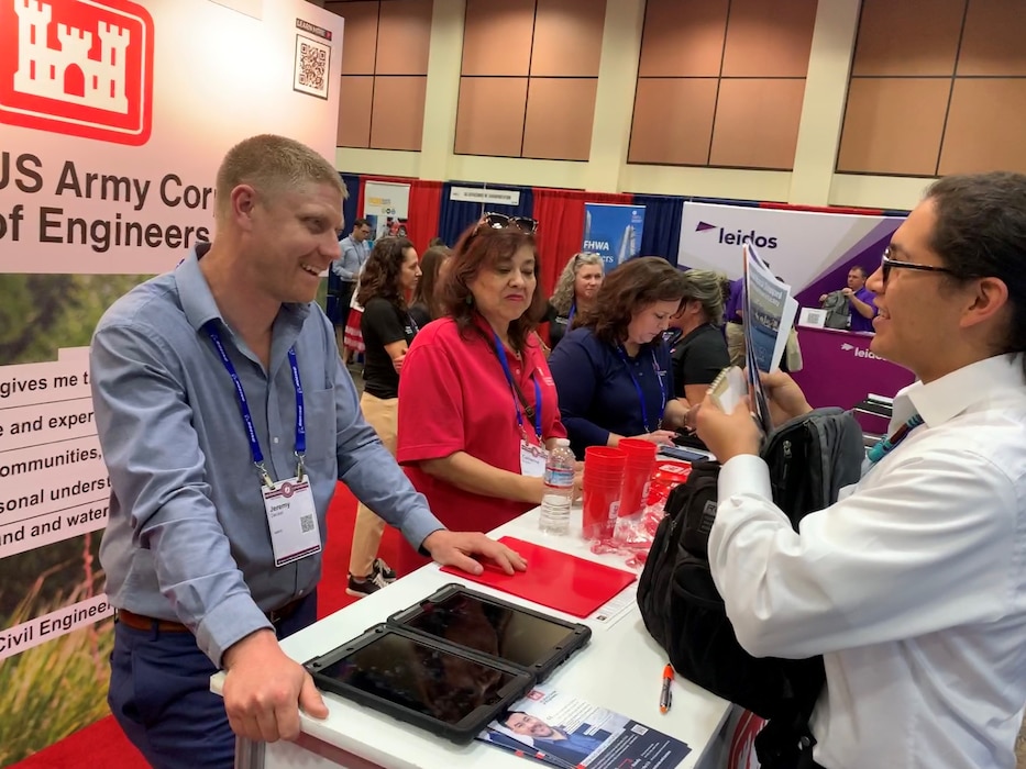 Koi Quiver, right, a mechanical engineer major at Northern Arizona University, talks with Jeremy Decker, an archeologist with the U.S. Army Corps of Engineers, during the American Indian Science and Engineering Society National Conference Oct. 7 in Palm Springs, California. Decker is a post-graduate student of Northern Arizona University class of 2007.