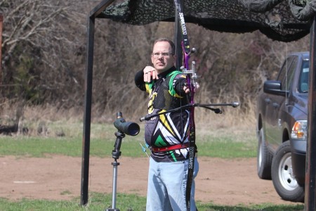 Sgt. 1st Class Scott Bowman, trombonist with the 77th Army Band, practices his archery with a recurve bow at a shooting range across from Fort Sill&#39;s majestic Medicine Bluff.