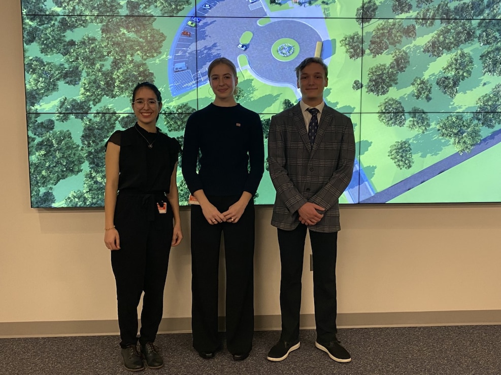 High School students Juliette Schaefer, Leah Kreeb and Will Hoffman pose in front of a rendering of their final project done as part of an internship with the U.S. Army Corps of Engineers Transatlantic Middle East District. Each year, the District hosts several high school interns during the fall and spring semesters to foster an interest in engineering and architecture career fields.