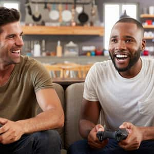 Two friends playing video games in basement