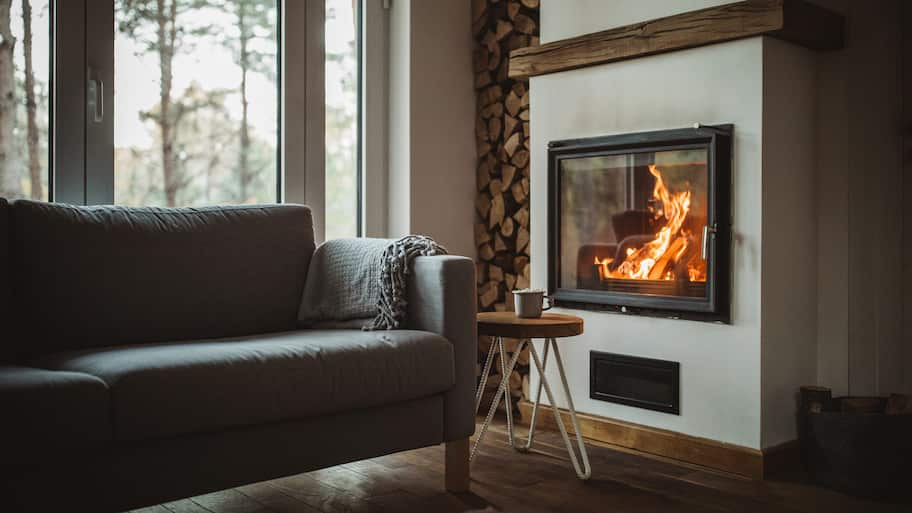 A cozy living room with a burning fireplace