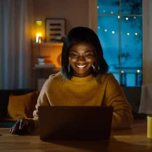 A woman working from her home in the evening