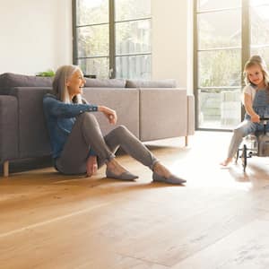  grandmother playing with kids on hardwood floor in living room