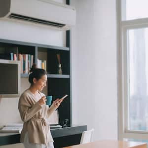 Woman drinking coffee and checking her phone