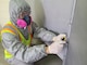 Kim Kyong-ho, U.S. Army Corps of Engineers Far East District Geotechnical Branch chemist, takes a suspected asbestos sample from the gasket used for the duck system in Gwangju Air Base, June 2002. In FED’s asbestos lab, experts analyze asbestos building materials and air samples for worker protection and environmental indoor air quality. (U.S. Army photo by U.S. Army Corps of Engineers Far East District)