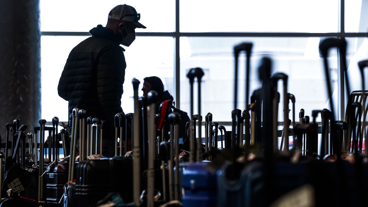 Travelers search for their suitcases in a baggage holding area for Southwest Airlines at Denver International Airport on December 28, 2022 in Denver, Colorado. More than 15,000 flights have been canceled by airlines since winter weather began impacting air travel on December 22. 