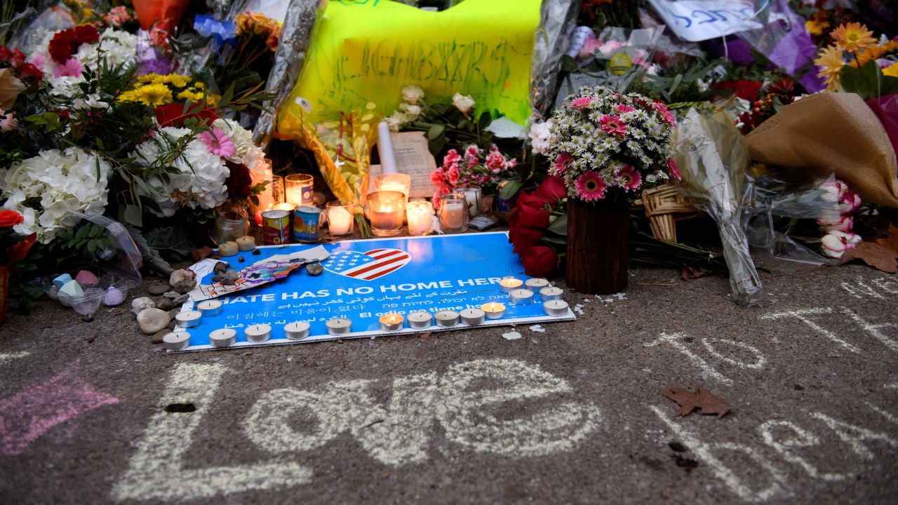 People pause in front of at a memorial for victims of the mass shooting that killed 11 people and wounded 6 at the Tree Of Life Synagogue on October 29, 2018 in Pittsburgh, Pennsylvania. President Donald Trump will be visiting the synagogue Tuesday to pay respects to the families of the victims. Eleven people were killed and six more wounded in the mass shooting that police say was fueled by antisemitism.