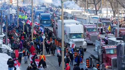 Supporters arrive at Parliament Hill for the Freedom Truck Convoy to protest against Covid-19 vaccine mandates and restrictions in Ottawa, Canada, on January 29, 2022. - Hundreds of truckers drove their giant rigs into the Canadian capital Ottawa on Saturday as part of a self-titled "Freedom Convoy" to protest vaccine mandates required to cross the US border. (Photo by Lars Hagberg / AFP) (Photo by LARS HAGBERG/AFP via Getty Images)