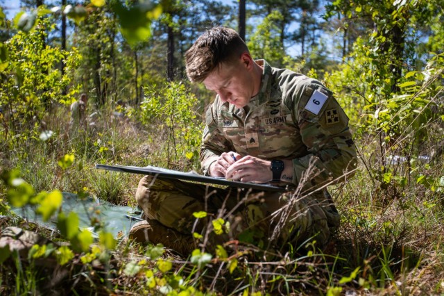 Sgt. Austin High from 2nd Squadron, 1st Cavalry Regiment, 1st Stryker Brigade Combat Team, 4th Infantry Division, uses a map and protractor to determine the distance between two plotted points during the 2023 Best Mortar Competition, Fort Benning, Georgia, April 10, 2023. Mortarmen use analog tools to first detrmine the distance between two points and then determine the elevation necessary to shoot mortar rounds that distance. 