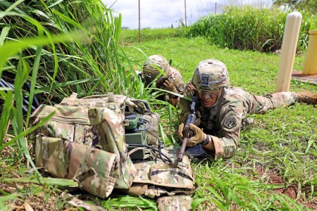 SCHOFIELD BARRACKS, Hawaii – 2nd Lt. Joe Larouche, mission commander for the 11th Cyber Battalion’s Expeditionary Cyber-Electromagnetic Activities Team-01, communicates with his higher headquarters about his team’s mission, while Staff Sgt. Ryan Hedgcoth, Expeditionary CEMA operator, keeps an eye on security, during an Operational Readiness Assessment for the battalion here, March 30, 2023.