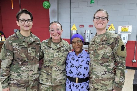 28th Infantry Division Soldiers posing with a Women&#39;s Army Corps veteran at the Women&#39;s History Month celebration held at Camp Arifjan, Kuwait. Women&#39;s History Month is an annual declared month that highlights the contributions of women to events in history and contemporary society.