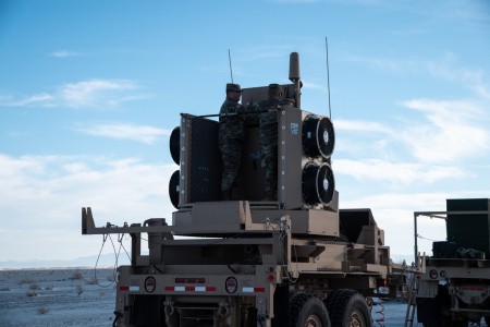 Staff Sgt. Takeshi Berdan, left, from Battery D, 6th Battalion 56th Air Defense Artillery Regiment, and Spc. Dylan Dominguez, right, from the North Dakota National Guard, both Army Air Defense Battle Management System Operators, prepare the Sentinel A4 for night operations against threat air objects.