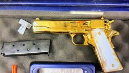 An undeclared 24-carat gold-plated handgun is pictured inside the luggage of a woman in Sydney on April 23, 2023.