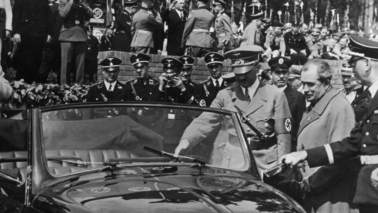 Nazi leader Adolf Hitler  inspects the new Volkswagen, or "people's car," in May 1938. 