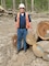 Barry Tucker, Louisville District forester, stands near harvested timber.