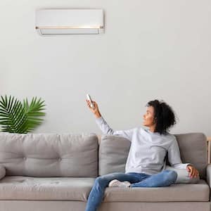 Woman using home AC unit