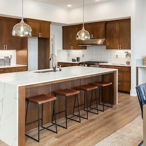 A luxury kitchen with a quartz waterfall island