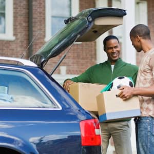 Father and son loading a car for a college move