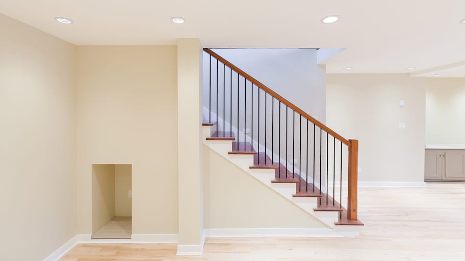 An empty basement with wooden stairs