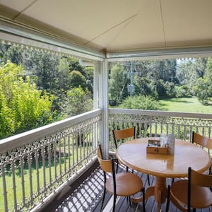 patio table and four chairs sit on screened in porch