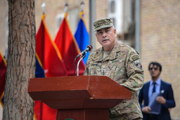 An Army general in uniform speaks at a podium.