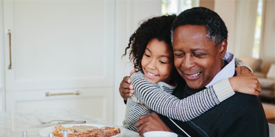 Black man hugging young Black girl