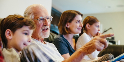 Multigenerational family, a grandfather is pointing something out to a grandson