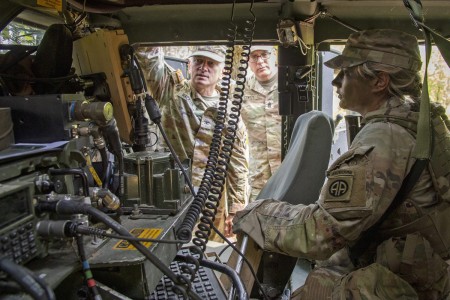 Pfc. Freya B. Dennis, platoon gunner and communications specialist from Alpha Troop, 1st Squadron, 73rd Cavalry Regiment, 2nd Brigade Combat Team, 82nd Airborne Division, demonstrates the Mounted Mission Command Software Version 3.1 software to U.S. Army Operational Test Command Commander Col. George C. Hackler, and OTC Command Sgt. Maj. Martin M. Conroy.