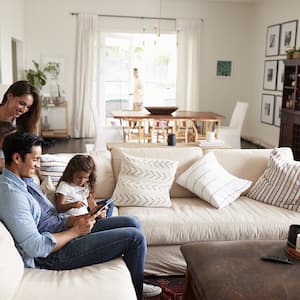 Young family smiling in living room