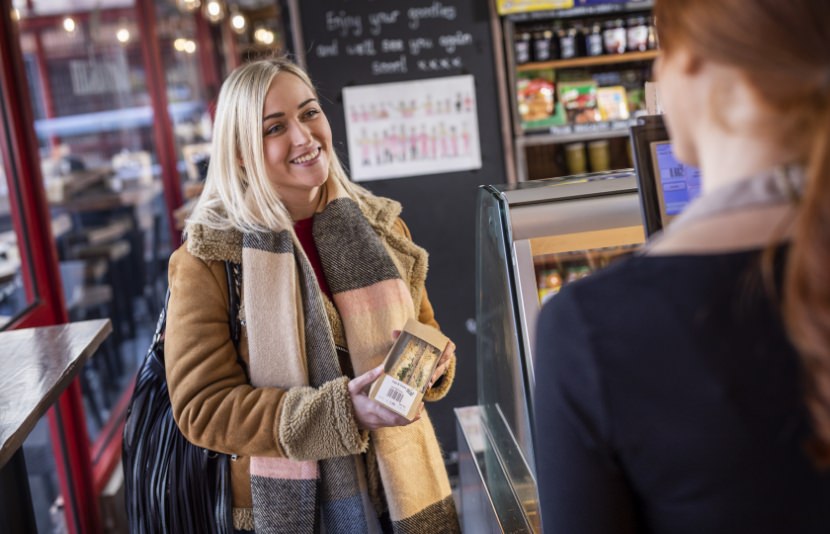 Female shopper buying a sandwich