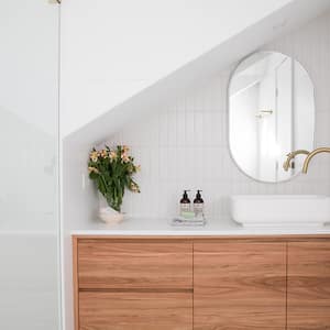 white bathroom with round mirror