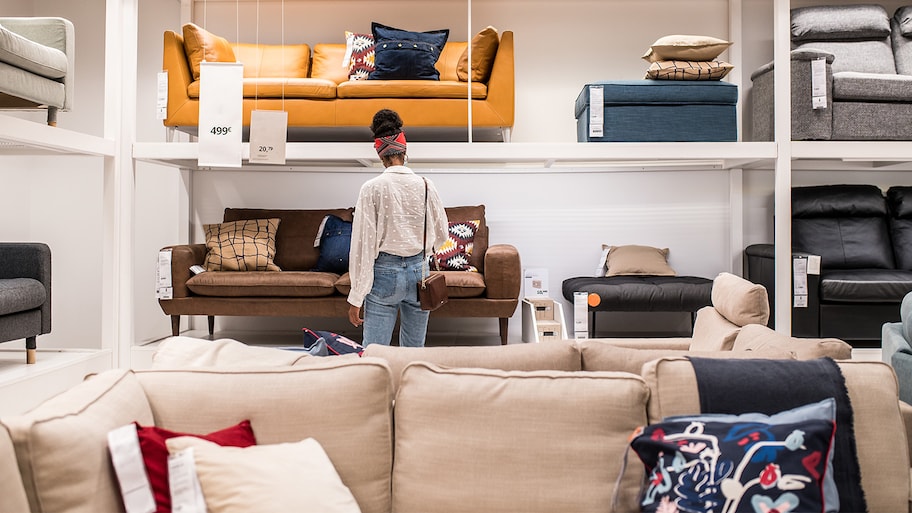 woman in furniture store looking at sofas