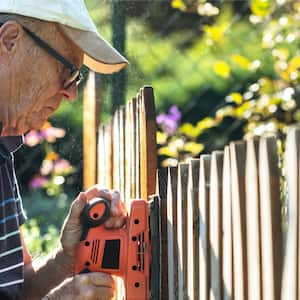 man installing fence covers