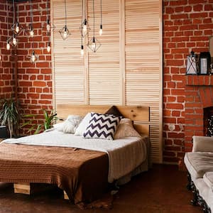 Bedroom with brick wall and fireplace